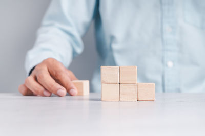 Midsection of man with toy on table