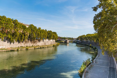 Arch bridge over river against sky