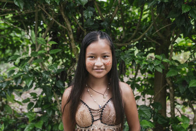 Smiling guarani girl against tree at misahualli, ecuador