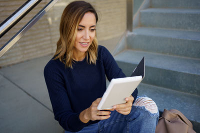 Young woman using digital tablet