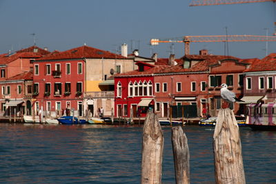 Boats in sea against buildings in city