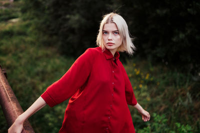 Blonde woman in nature in red shirt
