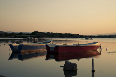 Boat moored on sea against clear sky