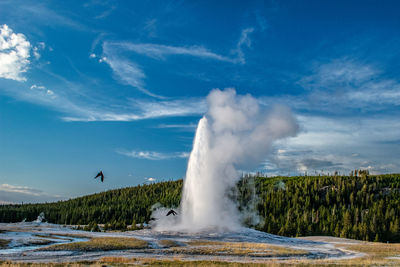 Scenic view of waterfall against sky