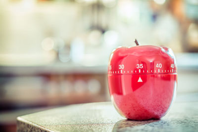 Close-up of apple shape dial on table