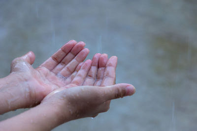 Cropped hands during rainy season