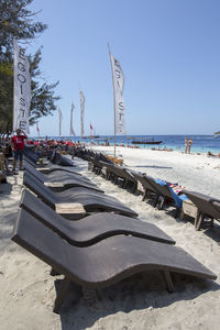 People on beach against clear sky