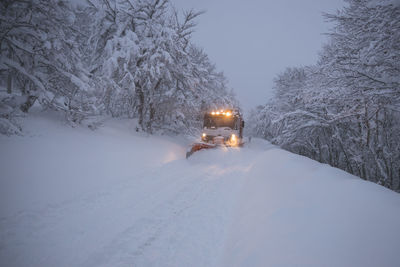 Snow blower working hard in high mountain