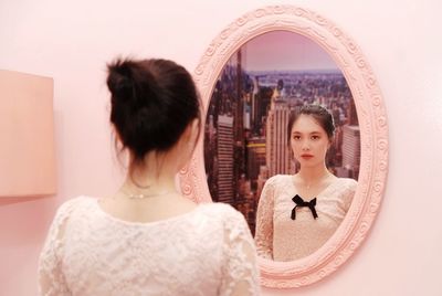 Rear view of woman standing at home