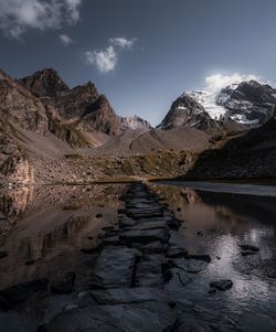 Scenic view of lake and mountains against sky