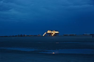 Scenic view of sea against blue sky at dusk