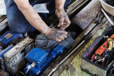 High angle view of man repairing machinery