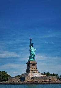 Statue of liberty against cloudy sky