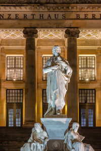 Low angle view of statue against building