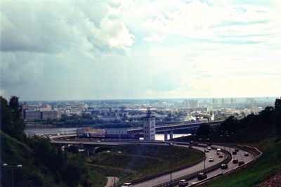 View of cityscape against cloudy sky