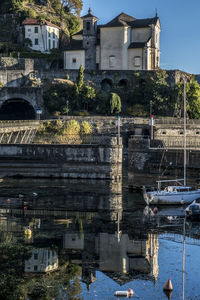 Church that is reflecting in the lake maggiore in maccagno