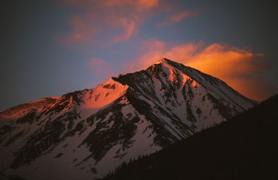 Scenic view of snow covered mountain against sky during sunset
