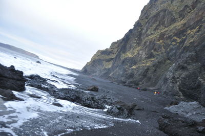 Scenic view of sea and mountains against sky