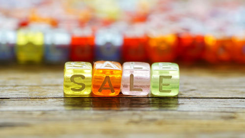 Close-up of sale text on colorful blocks over table