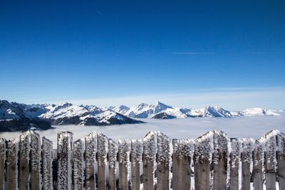 Scenic of snowcapped mountains against blue sky