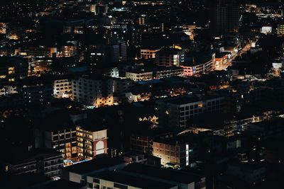 High angle view of illuminated buildings in city at night