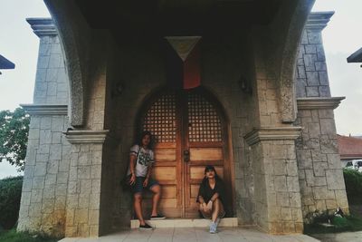 People standing by historic building