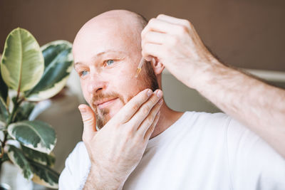 Close-up of man with eyes closed against plants