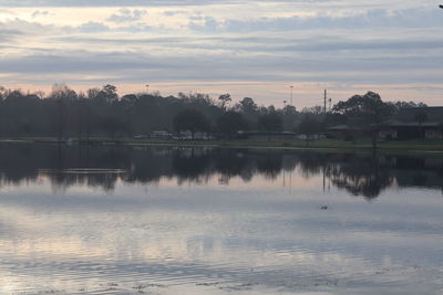 Scenic view of lake against sky at sunset