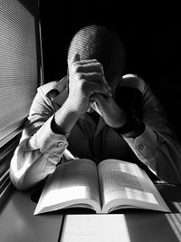 Man reading book in room