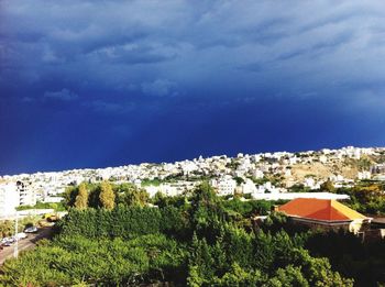 Houses against cloudy sky