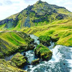 Scenic view of waterfall against sky