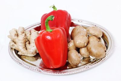 Close-up of food in plate against white background