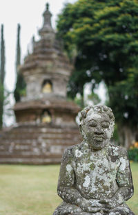 Statue of buddha against building