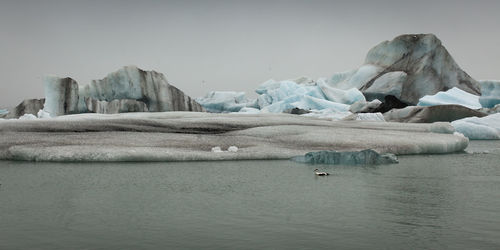 Scenic view of frozen lake against sky