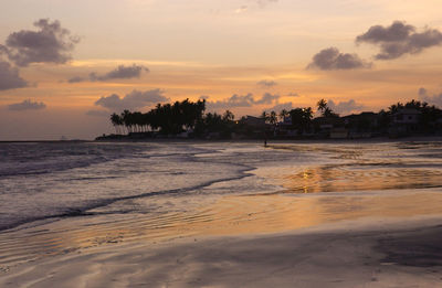 Scenic view of beach against sky during sunset