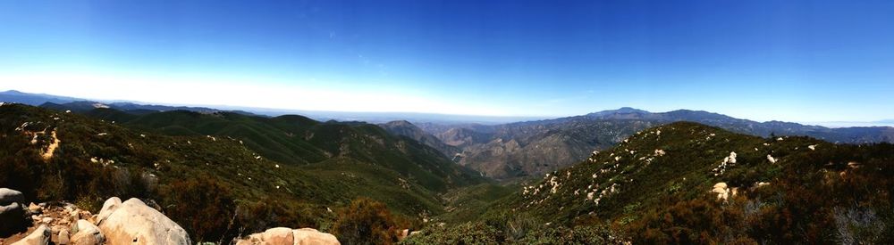 Scenic view of mountains against clear blue sky