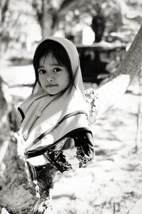 Portrait of girl sitting on a tree