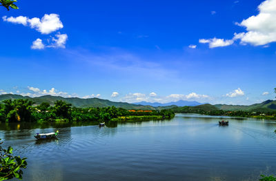 Ferry sailing in river against sky