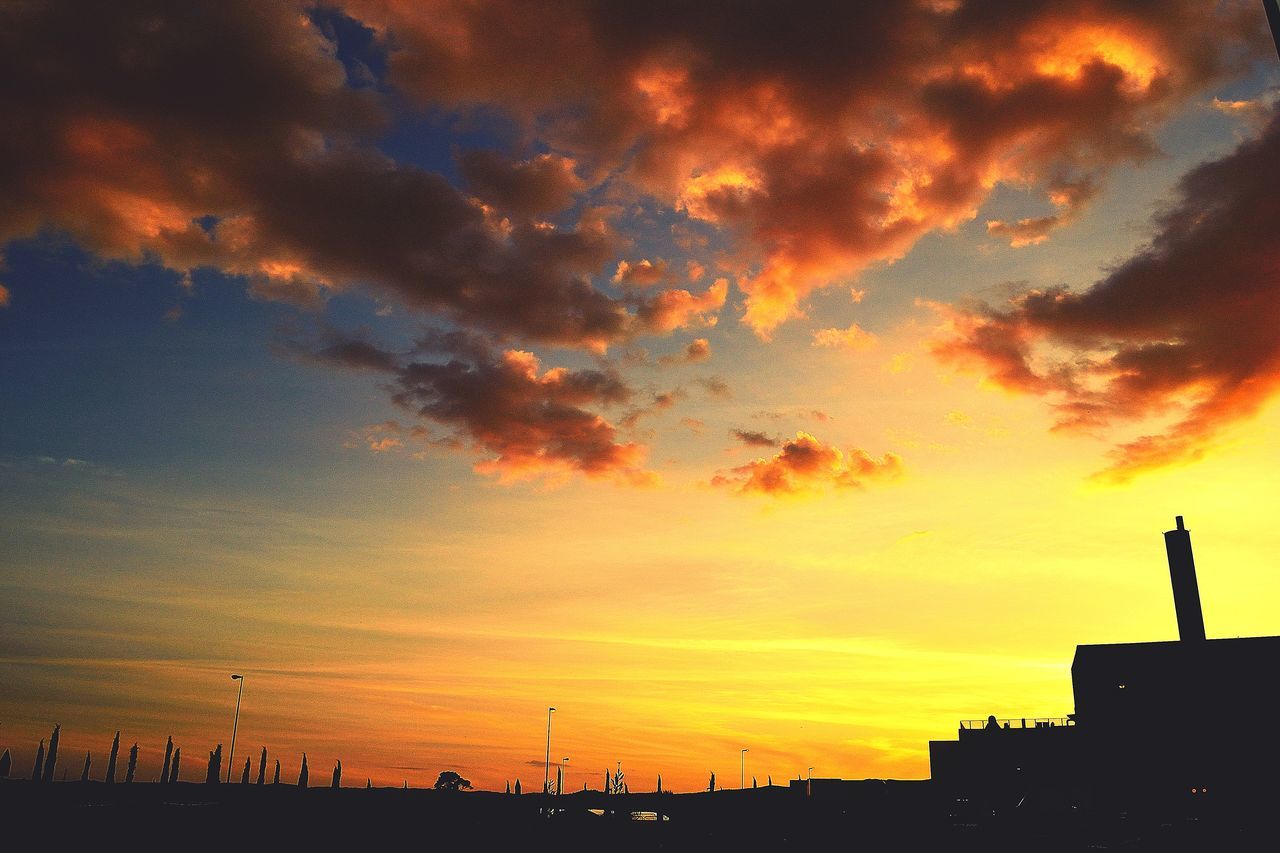 SILHOUETTE BUILDINGS AGAINST SKY DURING SUNSET