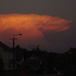 Low angle view of silhouette buildings against sky at sunset