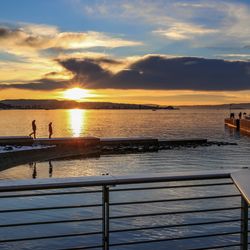 Pier on sea at sunset