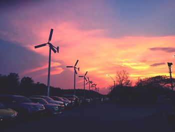 Cars on road against sky during sunset