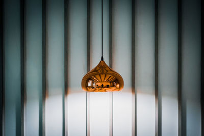 Close-up of pendant light hanging on wall