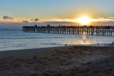Scenic view of beach against sky during sunset