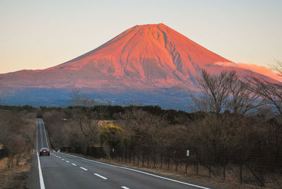 Road by mount fuji against sky