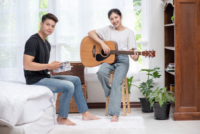 People playing guitar at music concert