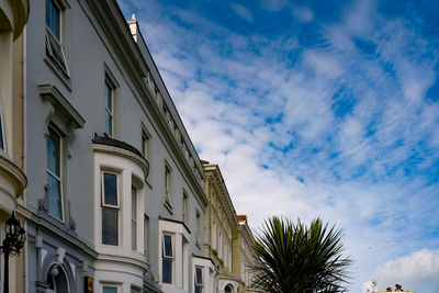 Low angle view of building against cloudy sky