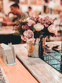 Close-up of flowers in container on table