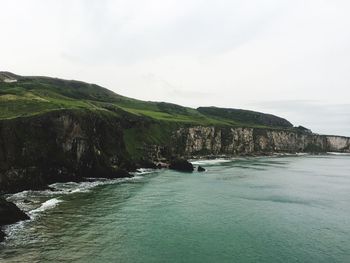 Scenic view of sea and mountains against sky