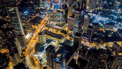 High angle view of city lit up at night